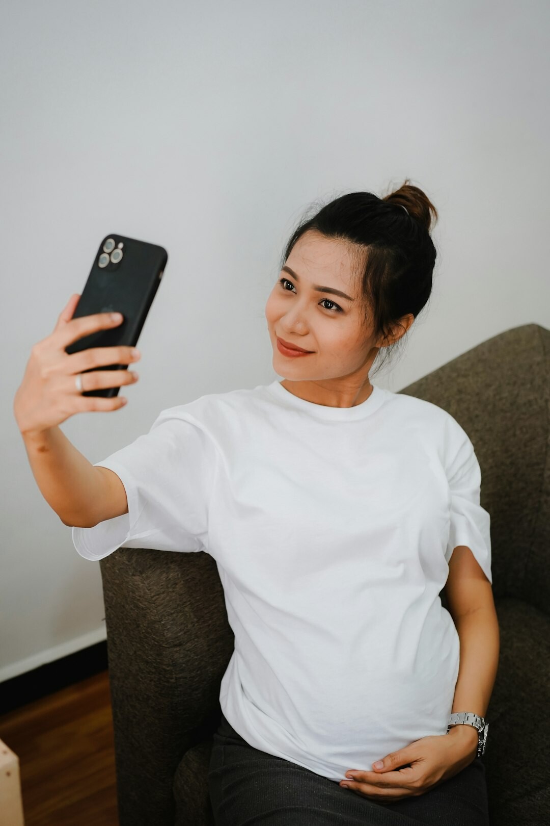 Singaporean health coach smiling during a video consultation