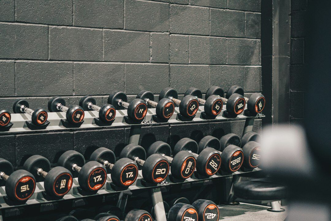 Modern gym interior with dumbbells and weight racks